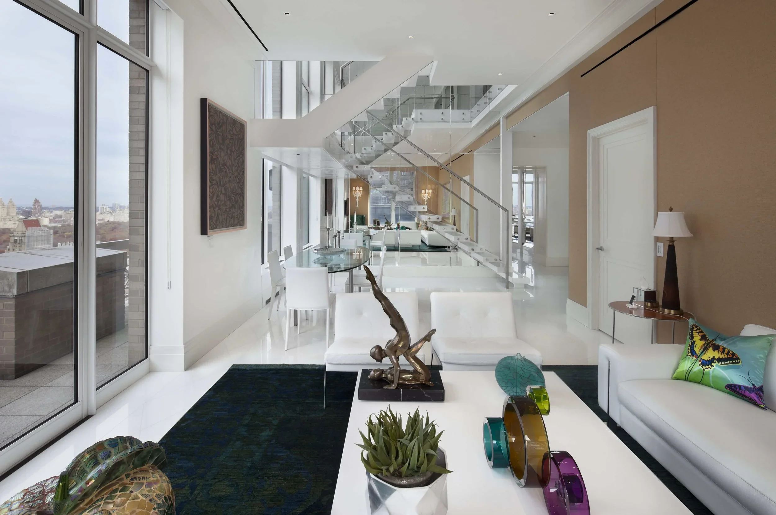 Sophisticated modern kitchen featuring dark wood cabinetry, glass-front displays, and marble backsplash in luxury residential project